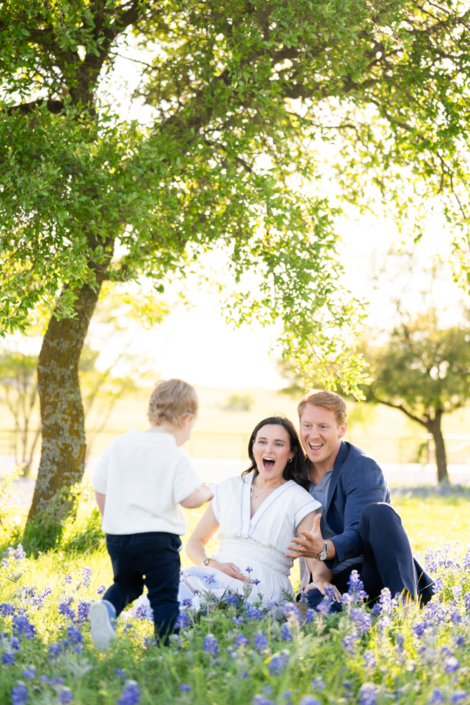 Early maternity portraits in the bluebonnets announcing a new baby
