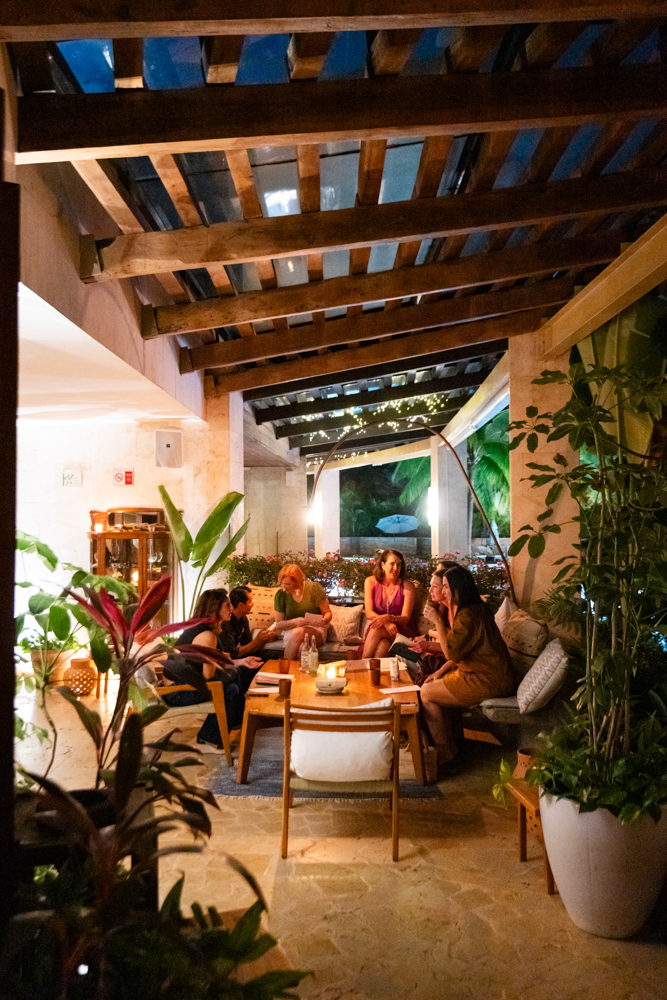 An open-air dining room filling with one of the dine around groups