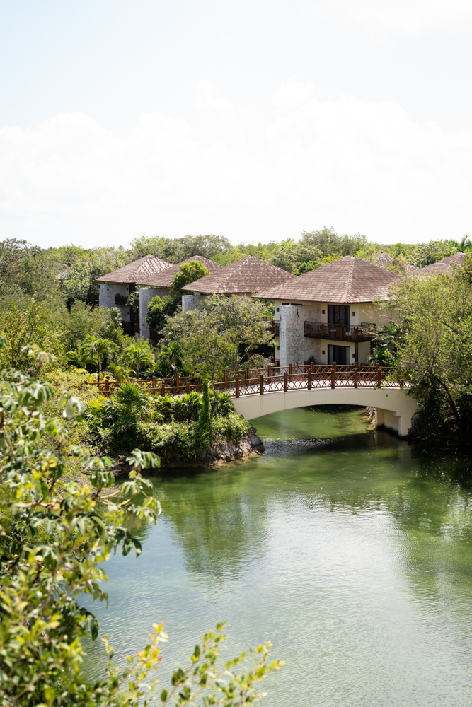 Palapa-roofed casitas reflected in one of the Mayakoba lagoons