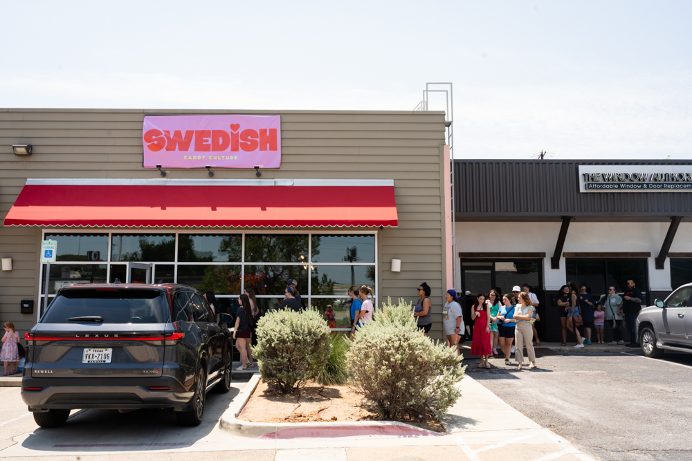 A line of customers stretching down the sidewalk outside Swedish Candy Culture on opening day in Fort Worth