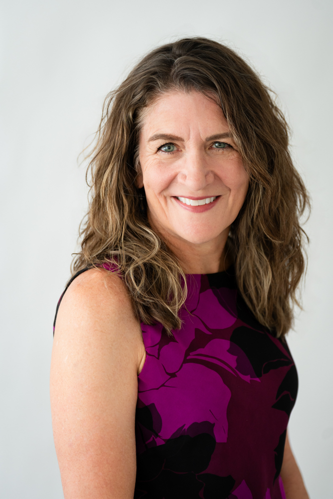 Kim Holden smiling warmly during her Fort Worth studio headshot session
